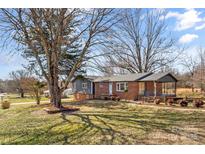 Charming brick home with well-manicured front yard and mature tree, offering great curb appeal at 605 18Th Nw St, Hickory, NC 28601