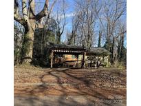 Charming single Gathering home featuring a covered porch and surrounded by mature trees in an established neighborhood at 1561 Westdale Dr, Charlotte, NC 28208