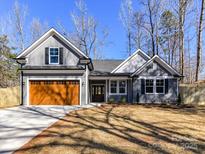 Charming gray home featuring a two-car garage, a well-manicured lawn, and a welcoming front entry at 2328 Kingsburry Rd, York, SC 29745