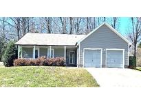 Charming single-story home with an attached two-car garage and a well-manicured front lawn at 2630 Sloan Dr, Charlotte, NC 28208