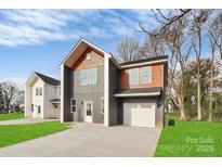 Modern two-story home featuring mixed siding, an attached garage, and a well-maintained front lawn at 2751 Bradford St, Gastonia, NC 28052
