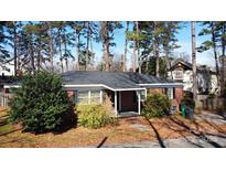 Charming brick ranch-style home with a covered front porch and mature landscaping at 2921 Fort St, Charlotte, NC 28205