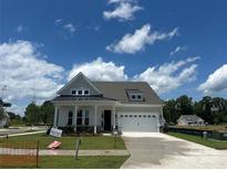 Charming single-Gathering home boasting craftsman-style architecture and a well-manicured front lawn at 305 Basil Dr, Indian Trail, NC 28079