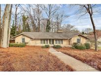 Charming brick home featuring a well-manicured lawn and inviting walkway at 3200 Highview Rd, Charlotte, NC 28210