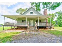 Charming home featuring a covered porch, stone steps and a brick chimney at 3640 Oak Haven Ln, Shelby, NC 28150