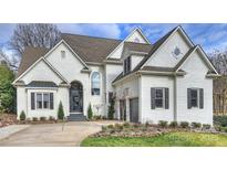 Charming two-story brick home featuring a manicured front yard and attached two-car garage at 5231 Lila Wood Cir, Charlotte, NC 28209