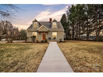 Charming two-story home features a welcoming walkway and well-maintained front yard at 56 Linneys Mountain Rd, Taylorsville, NC 28681
