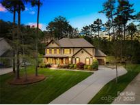 Charming two-story home with a well-manicured lawn and a long driveway at 113 Sandy Cove Ct, Mooresville, NC 28117