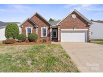 Charming brick home with a two-car garage and well-maintained landscaping at 1207 Overhill Rd, Salisbury, NC 28144