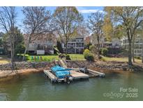 Picturesque waterfront property with a private dock, showcasing serene lake views and beautiful landscaping at 17701 Springwinds Dr, Cornelius, NC 28031