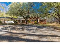 Charming brick home with a covered parking area and beautiful mature trees in a spacious front yard at 1774 Hwy 55 E Hwy, Clover, SC 29710