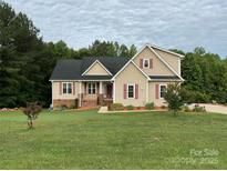 Charming two-story home with red shutters, brick accents, covered porch, and well-manicured lawn at 2050 Sunswept Ln, York, SC 29745