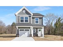 Charming two-story home with a gray exterior, white trim, and an attached garage at 2125 Tom Sadler Rd # 7159, Charlotte, NC 28214
