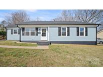 Charming single-story home with light blue siding, black shutters, and well-maintained front yard at 2509 Lanecrest Dr, Charlotte, NC 28215