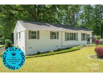 Charming single-story home with a well-maintained lawn and freshly painted brick exterior at 3231 Eastwood Dr, Charlotte, NC 28205