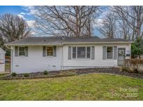 Charming single-story home with a well-maintained front lawn and classic architectural details at 3231 Eastwood Dr, Charlotte, NC 28205