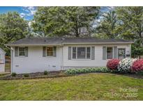 Charming single-story home featuring beautiful landscaping, a well-maintained lawn, and a welcoming front entrance at 3231 Eastwood Dr, Charlotte, NC 28205