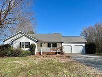 Charming single-story home with white siding, attached two-car garage, and well-maintained front yard at 326 Anderson Grove Church Rd, Albemarle, NC 28001