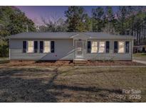 Charming single-story home featuring black shutters, a well-maintained lawn, and inviting front entrance at 3410 Nc 109 N Hwy, Wadesboro, NC 28170