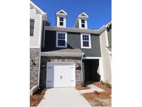 Charming two-story home with stone accents and a one-car garage on a sunny day at 3427 Secrest Lndg, Monroe, NC 28110