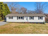 Charming single-story home with vinyl siding, black shutters, and a well-maintained lawn at 3598 Puett Park Dr, Conover, NC 28613