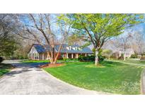 Beautiful brick home with manicured lawn, mature trees and circular drive at 4025 4Th Street Nw Ln, Hickory, NC 28601