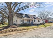 Charming two-story home with a covered front porch and mature trees at 406 E 29Th St, Kannapolis, NC 28083