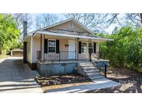 Charming one-story home with a cozy front porch and black shutters, nestled in a tree-lined neighborhood at 624 Harris Nw St, Concord, NC 28025