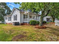 Charming single-Gathering home with a well-maintained lawn and a cozy front porch at 1006 N Ridge Ave, Kannapolis, NC 28083