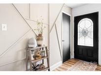 Stylish entryway featuring decorative wall trim, hardwood floors, and a black front door with glass detailing at 104 Pop Davis Rd, Taylorsville, NC 28681