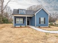 Charming blue home with black shutters, white trim, dormer, and sidewalk to the front door at 1137 Williams St, Rock Hill, SC 29732