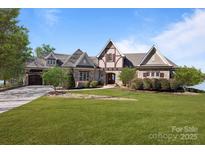 Charming exterior with stone accents and meticulously manicured lawn, exuding timeless elegance at 134 Larkhaven Ln, Mooresville, NC 28117