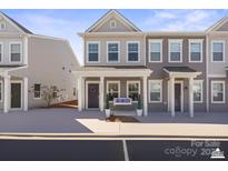 Charming townhome featuring a welcoming front porch and a swing for relaxing at 13850 Clayborn St, Midland, NC 28107