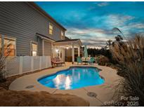 Inviting backyard pool with a patio and lounge chairs, perfect for relaxing evenings and outdoor entertaining at 2033 Folkstone Ln, Indian Land, SC 29720