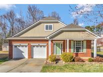 Charming brick home with a two-car garage, manicured lawn and attractive curb appeal at 571 Rough Hewn Ln, Rock Hill, SC 29730