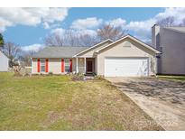 Charming single-story home with vinyl siding, attached garage, and well-maintained front yard at 14429 Planters Knob Ln, Charlotte, NC 28273