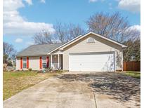 Charming single-story home featuring a two-car garage, red shutters, and a well-manicured front yard at 14429 Planters Knob Ln, Charlotte, NC 28273
