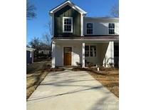 Charming two-story home with a welcoming porch and well-manicured lawn at 1520 Norris Ave, Charlotte, NC 28206