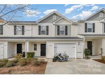 Attractive townhome with vinyl siding, black shutters and a one-car garage at 2026 Talbert Ct, Charlotte, NC 28214