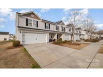 Charming townhome featuring attached garage and inviting curb appeal at 2026 Talbert Ct, Charlotte, NC 28214