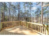 New wood deck overlooking a wooded area with natural sunlight coming through the tall trees at 2206 Hillcrest Ave, Albemarle, NC 28001