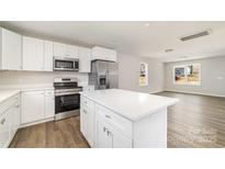 Modern kitchen with white cabinets, stainless steel appliances, and a center island at 2206 Hillcrest Ave, Albemarle, NC 28001