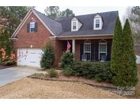 Charming brick home with a manicured front yard and cozy porch at 4006 Hickory View Dr, Fort Mill, SC 29707
