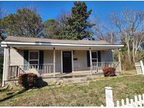 Charming single-story home with a welcoming front porch and a well-maintained yard at 44 Fenix Sw Dr, Concord, NC 28025