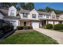 Charming townhome featuring a well-manicured lawn, attached garage and lovely curb appeal at 4586 Antelope Ln, Charlotte, NC 28269