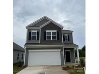 Charming two-story home featuring gray siding, black shutters, and a prominent two-car garage at 1101 Red River Dr, Salisbury, NC 28144