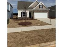 New construction home featuring stone accents, a two-car garage, and a well-maintained front yard at 1120 Red River Rd, Salisbury, NC 28144