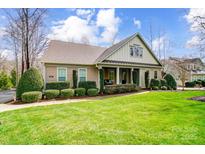 Charming single-story home with a well-manicured lawn and inviting curb appeal with colorful landscaping at 12811 Elkhorn Dr, Charlotte, NC 28278