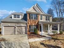 Charming two-story home featuring a two-car garage and a welcoming front porch at 21005 Brinkley St, Cornelius, NC 28031