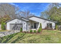 Charming one-story home with gray garage door, manicured lawn and welcoming covered front entry at 3612 Bon Rea Dr, Charlotte, NC 28226
